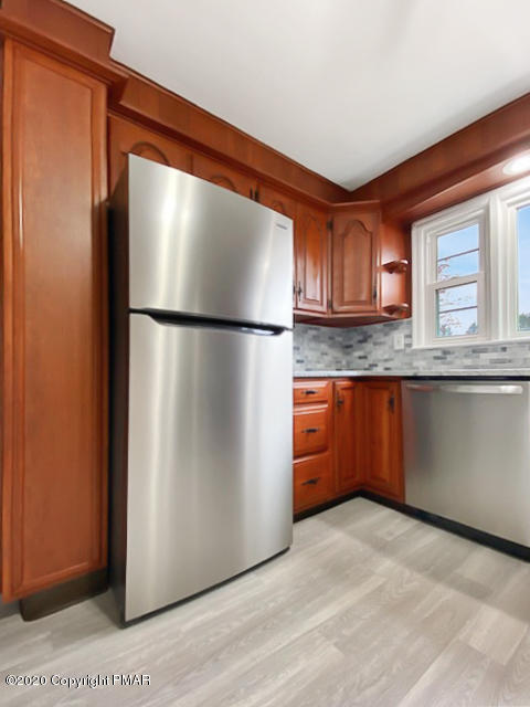 7522 Old Coach Road Stroudsburg, PA 18360 - Photo 29 of 68 a kitchen with stainless steel appliances granite countertop a refrigerator a sink and a granite counter tops