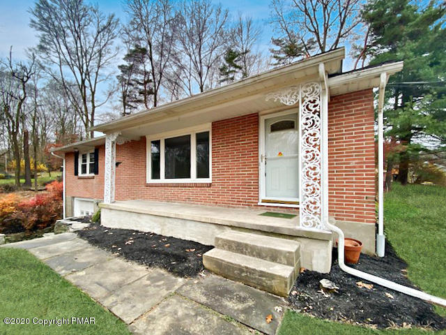 7522 Old Coach Road Stroudsburg, PA 18360 - Photo 3 of 68 a front view of a house with a yard