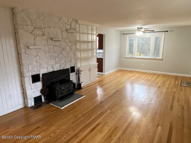 7522 Old Coach Road Stroudsburg, PA 18360 - Photo 37 of 68 a view of empty room with fireplace and wooden floor