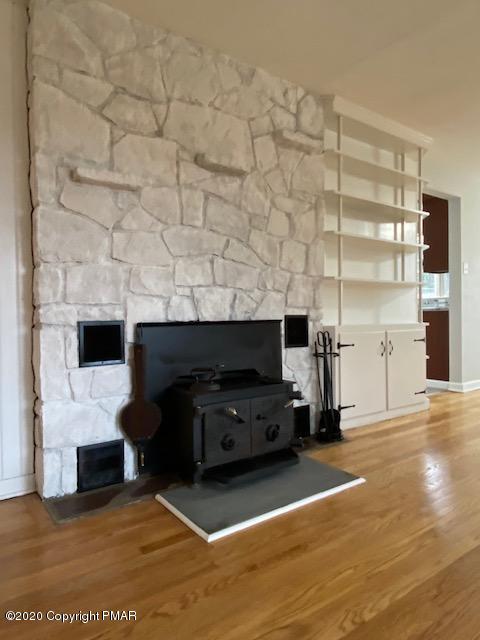7522 Old Coach Road Stroudsburg, PA 18360 - Photo 39 of 68 a living room with furniture a fireplace and a flat screen tv