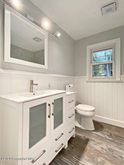 7522 Old Coach Road Stroudsburg, PA 18360 - Photo 40 of 68 a spacious bathroom with a toilet sink and mirror