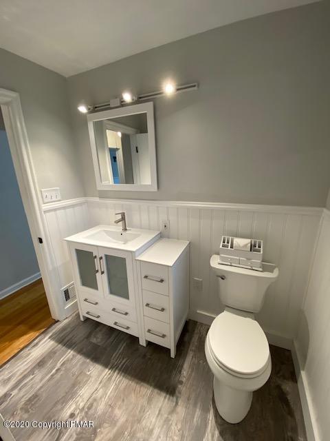 7522 Old Coach Road Stroudsburg, PA 18360 - Photo 43 of 68 a bathroom with a toilet sink and mirror