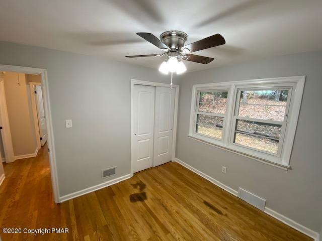 7522 Old Coach Road Stroudsburg, PA 18360 - Photo 53 of 68 a view of an empty room with wooden floor and a window