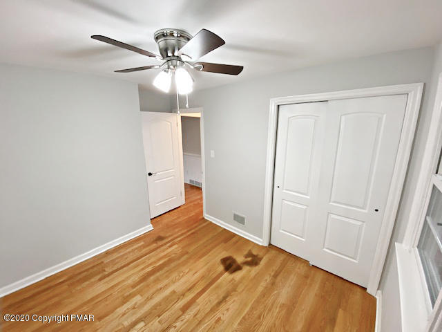 7522 Old Coach Road Stroudsburg, PA 18360 - Photo 57 of 68 a view of empty room with wooden floor and fan
