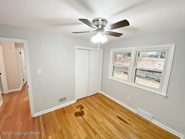 7522 Old Coach Road Stroudsburg, PA 18360 - Photo 58 of 68 a view of an empty room with wooden floor and a window