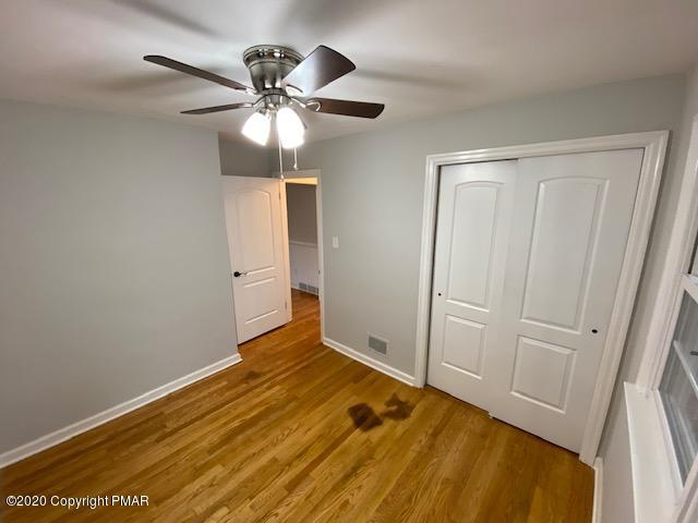 7522 Old Coach Road Stroudsburg, PA 18360 - Photo 59 of 68 a view of empty room with wooden floor and fan