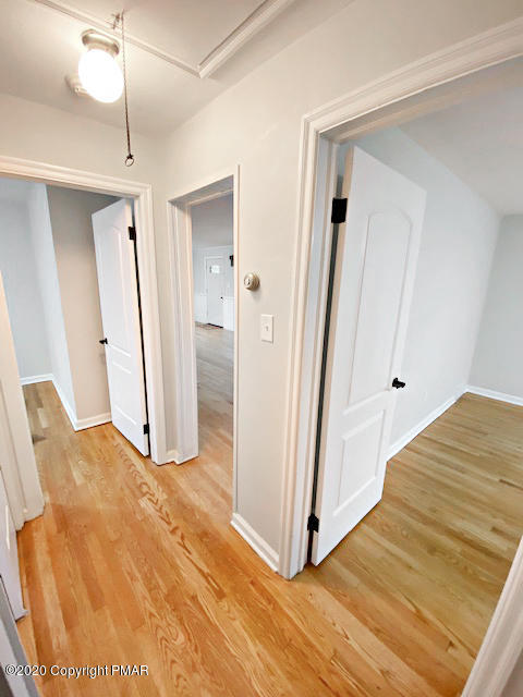 7522 Old Coach Road Stroudsburg, PA 18360 - Photo 60 of 68 a view of a hallway with wooden floor and staircase
