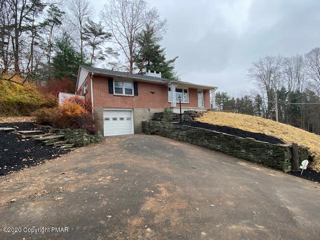 7522 Old Coach Road Stroudsburg, PA 18360 - Photo 6 of 68 a front view of a house with a yard
