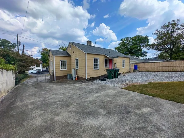 a view of backyard of house and car parked