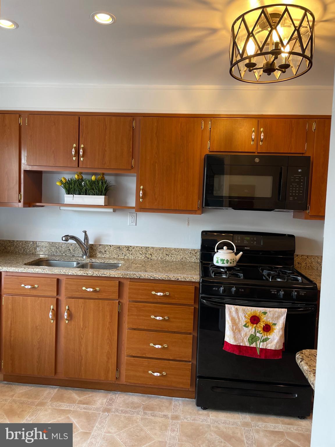 1407 Barrett Road Baltimore, MD 21207 - Photo 7 of 19 a kitchen with a stove and a microwave