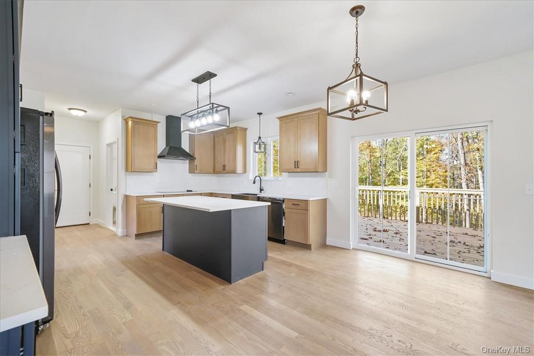Lot 3-62 Camp Monroe Road Monroe, NY 10950 - Photo 11 of 39 Kitchen featuring appliances with stainless steel finishes, hanging light fixtures, wall chimney range hood, and a kitchen island