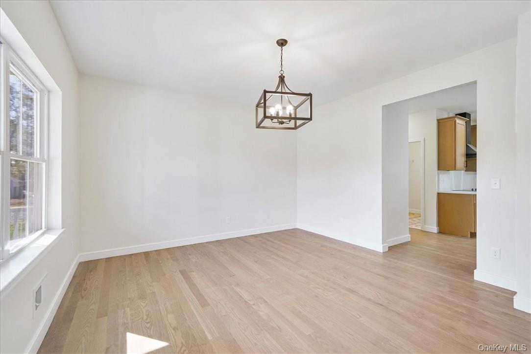 Lot 3-62 Camp Monroe Road Monroe, NY 10950 - Photo 18 of 39 Unfurnished room featuring plenty of natural light, a notable chandelier, and light wood-type flooring