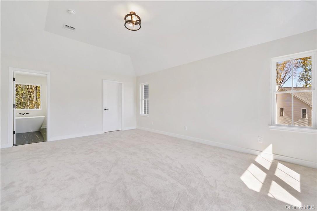 Lot 3-62 Camp Monroe Road Monroe, NY 10950 - Photo 21 of 39 Unfurnished bedroom featuring light carpet, vaulted ceiling, and multiple windows
