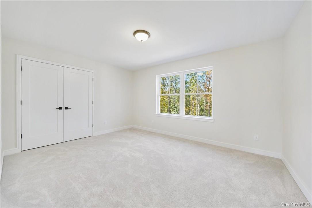 Lot 3-62 Camp Monroe Road Monroe, NY 10950 - Photo 29 of 39 Unfurnished bedroom with light carpet and a closet