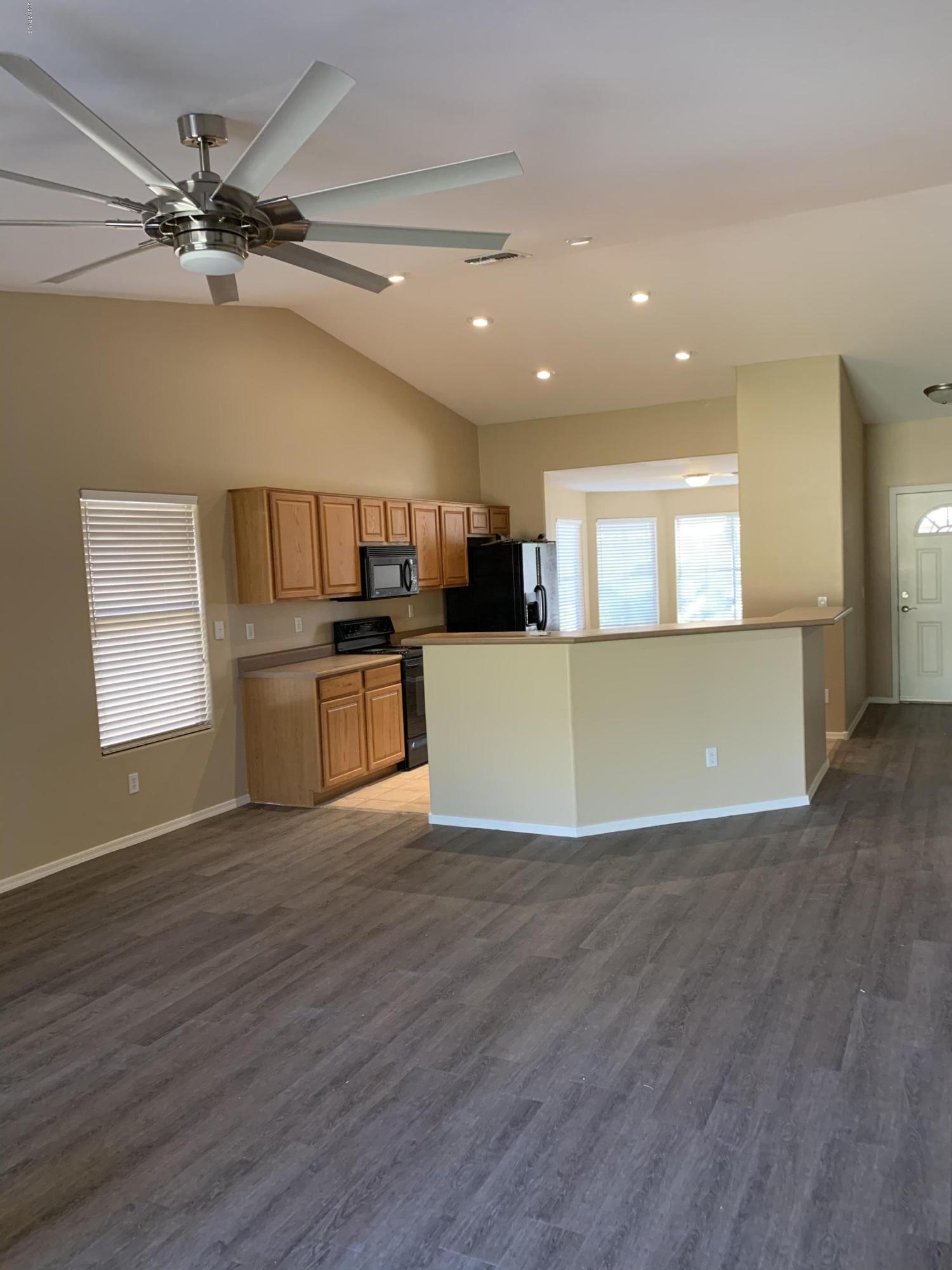 2306 West Maldonado Road Phoenix, AZ 85041 - Photo 7 of 14 a view of a kitchen with a sink cabinets and wooden floor