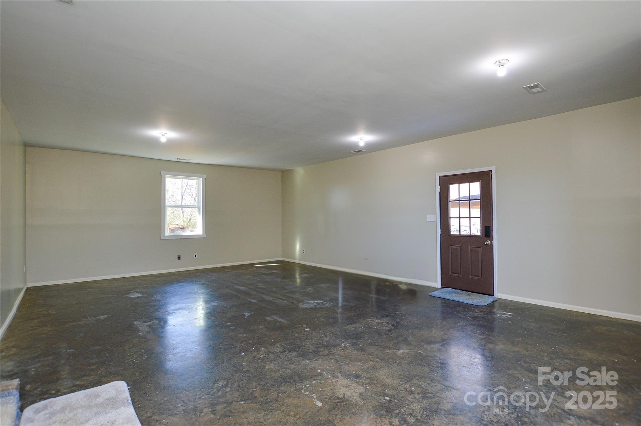 6615 Love Mill Road Monroe, NC 28110 - Photo 24 of 37 an empty room with wooden floor and windows