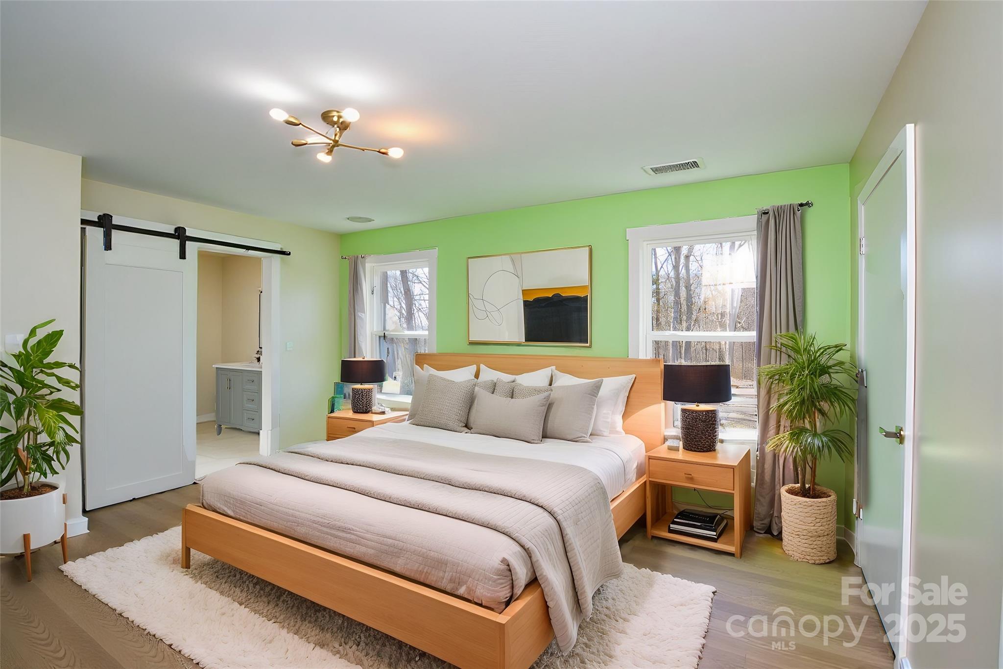 6615 Love Mill Road Monroe, NC 28110 - Photo 26 of 37 a bedroom with a large bed and a potted plant