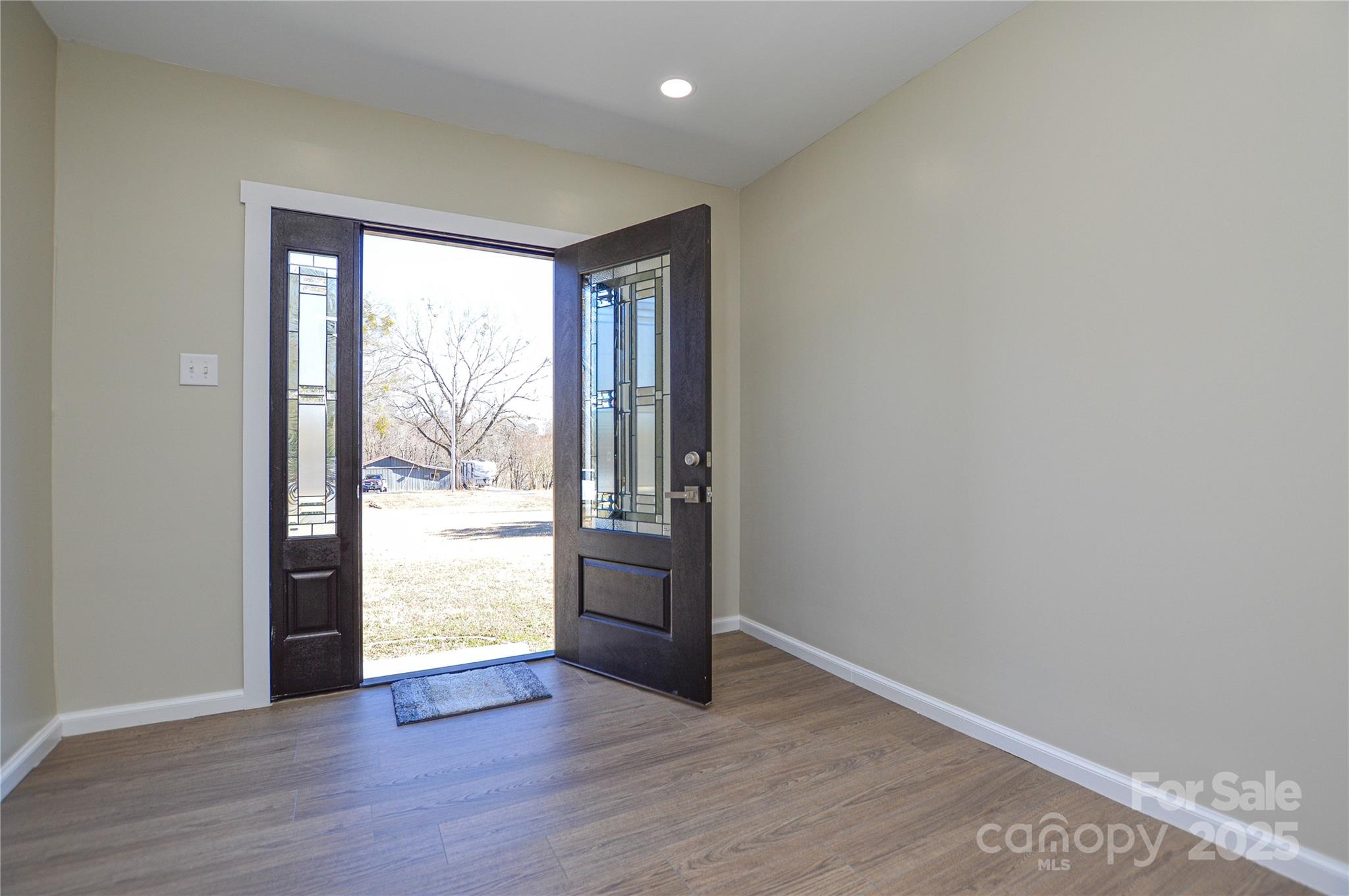 6615 Love Mill Road Monroe, NC 28110 - Photo 34 of 37 a view of an empty room with wooden floor and a window