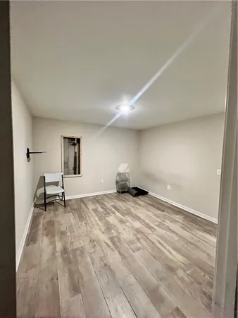 a view of a livingroom with wooden floor and window