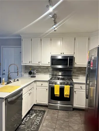 a kitchen with a sink a stove and cabinets