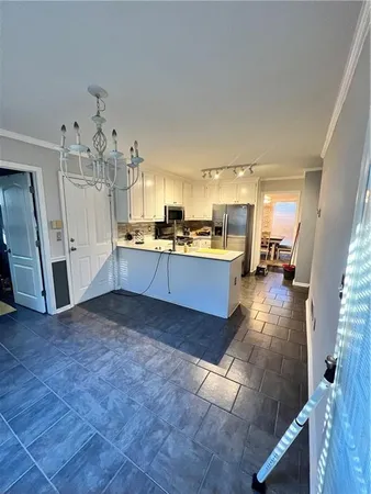 a view of a kitchen with a sink cabinets and a living room
