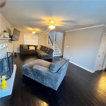 a living room with couches and painting on the wall