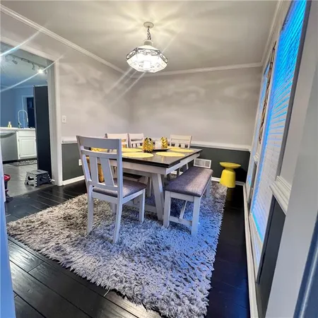 a dining room with a table and chairs