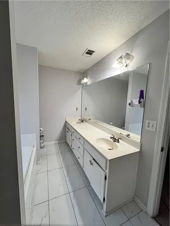 a bathroom with a sink vanity and mirror
