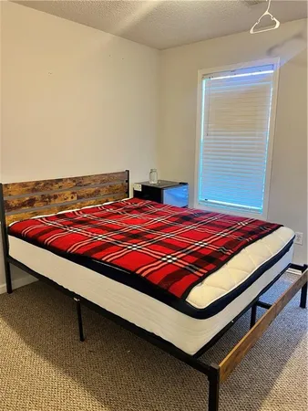 a bedroom with a bed and window