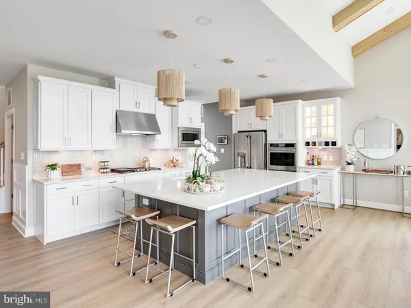 a kitchen with stainless steel appliances granite countertop a sink and a refrigerator