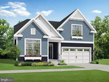 a front view of a house with a garden and yard