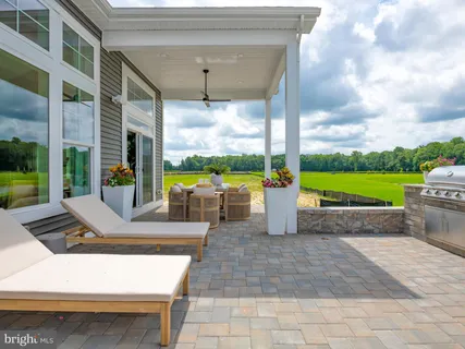 a view of a balcony with chairs and a potted plant