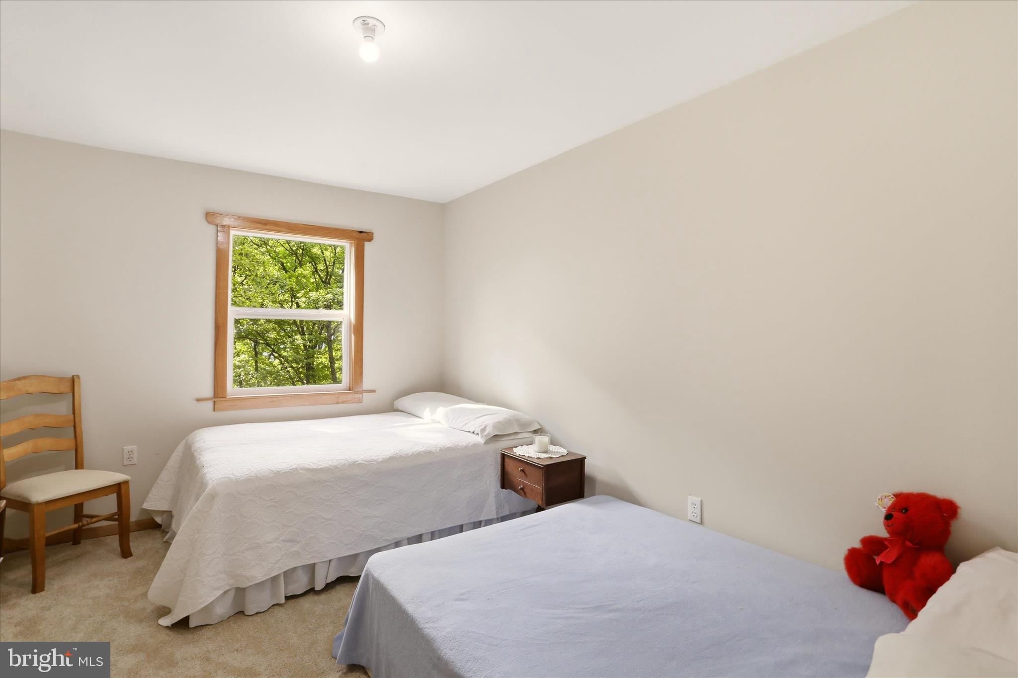 936 Johnny Cake Road Great Cacapon, WV 25422 - Photo 22 of 33 a bedroom with two beds and a window
