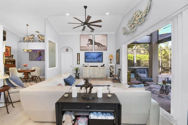 a kitchen with stainless steel appliances kitchen island granite countertop a table chairs and a refrigerator
