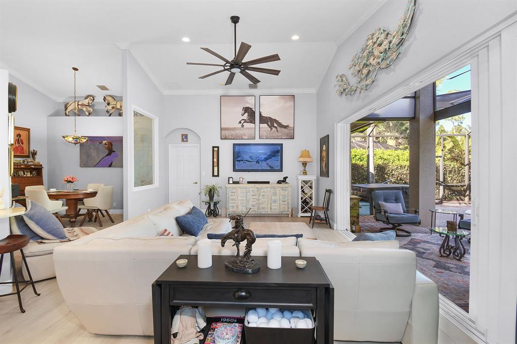 6848 Southeast Twin Oaks Circle Stuart, FL 34997 - Photo 12 of 70 a living room with furniture a flat screen tv and a large window