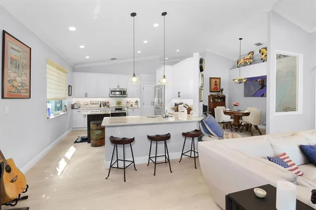 a kitchen that has a sink and a stove in it