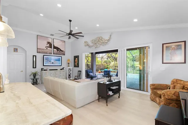 a kitchen with a sink a stove a refrigerator and white cabinets