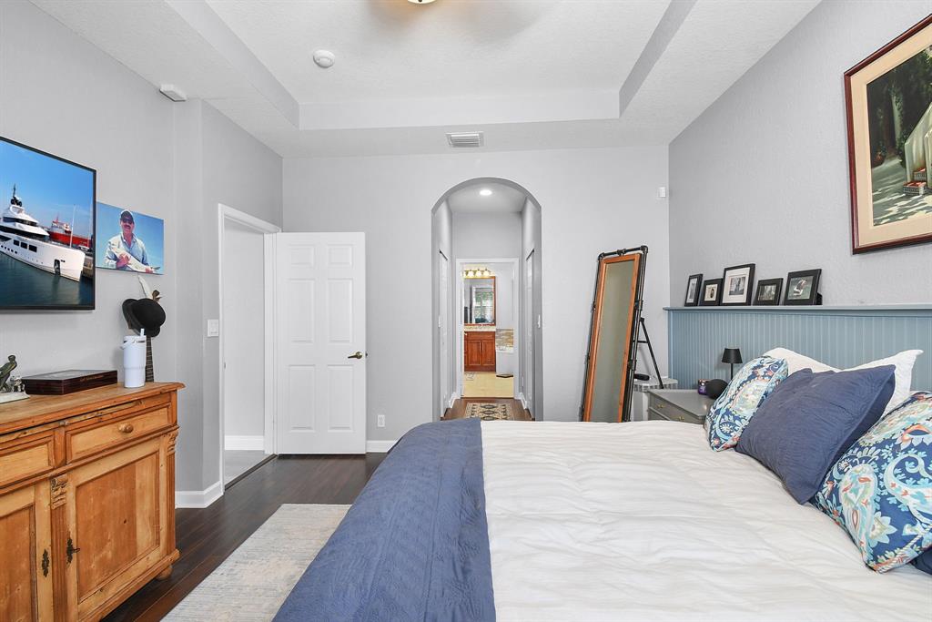 6848 Southeast Twin Oaks Circle Stuart, FL 34997 - Photo 22 of 70 a bedroom with a bed and a flat screen tv