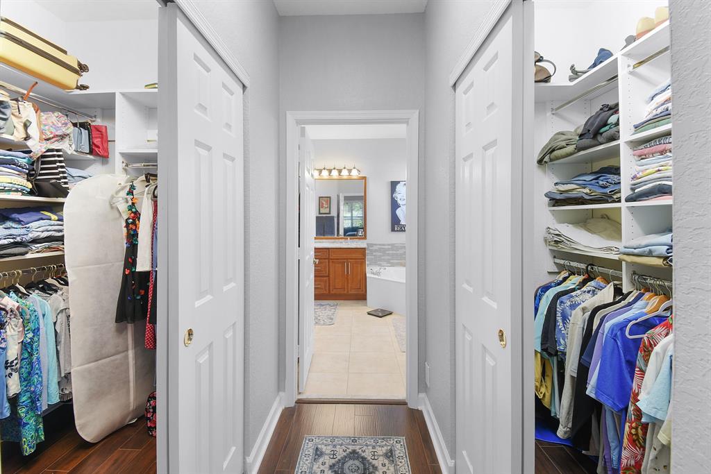 6848 Southeast Twin Oaks Circle Stuart, FL 34997 - Photo 24 of 70 a view of walk in closet with clothes and shoes