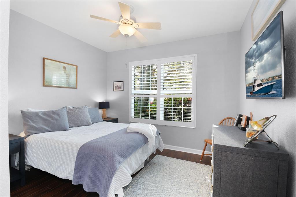 6848 Southeast Twin Oaks Circle Stuart, FL 34997 - Photo 28 of 70 a bedroom with a bed and a window