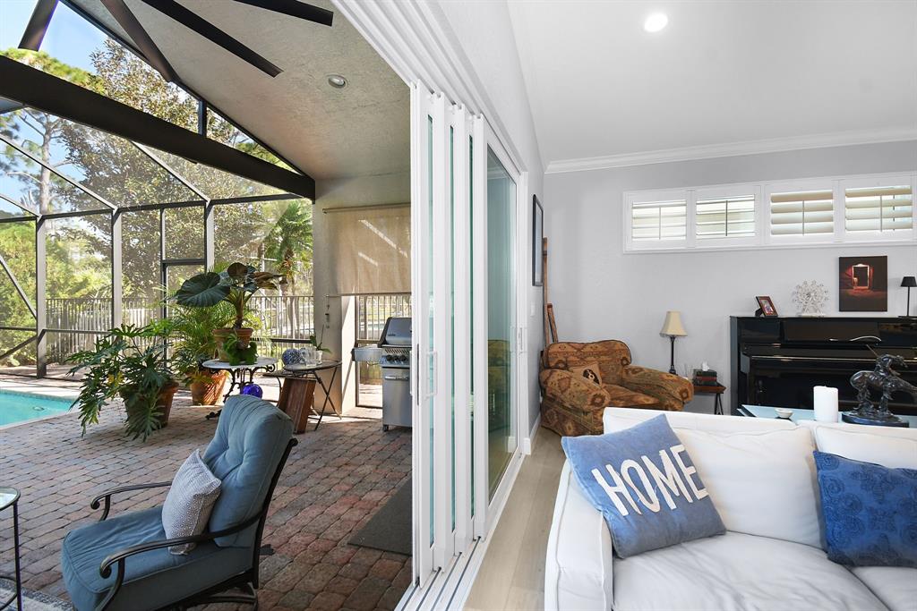 6848 Southeast Twin Oaks Circle Stuart, FL 34997 - Photo 34 of 70 a living room with furniture and a potted plant