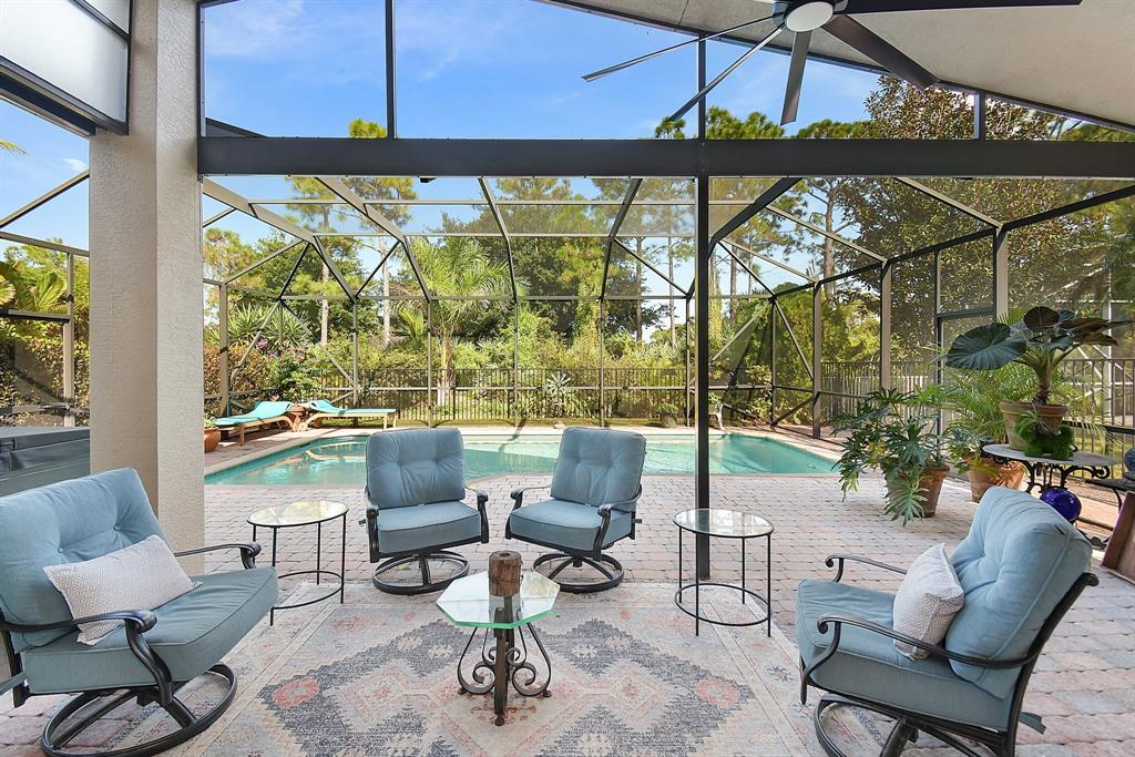 6848 Southeast Twin Oaks Circle Stuart, FL 34997 - Photo 35 of 70 a living room with patio furniture and a floor to ceiling window