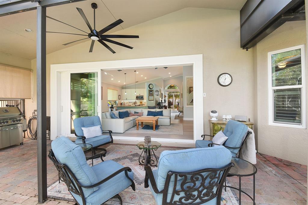 6848 Southeast Twin Oaks Circle Stuart, FL 34997 - Photo 36 of 70 a living room with furniture and a large window