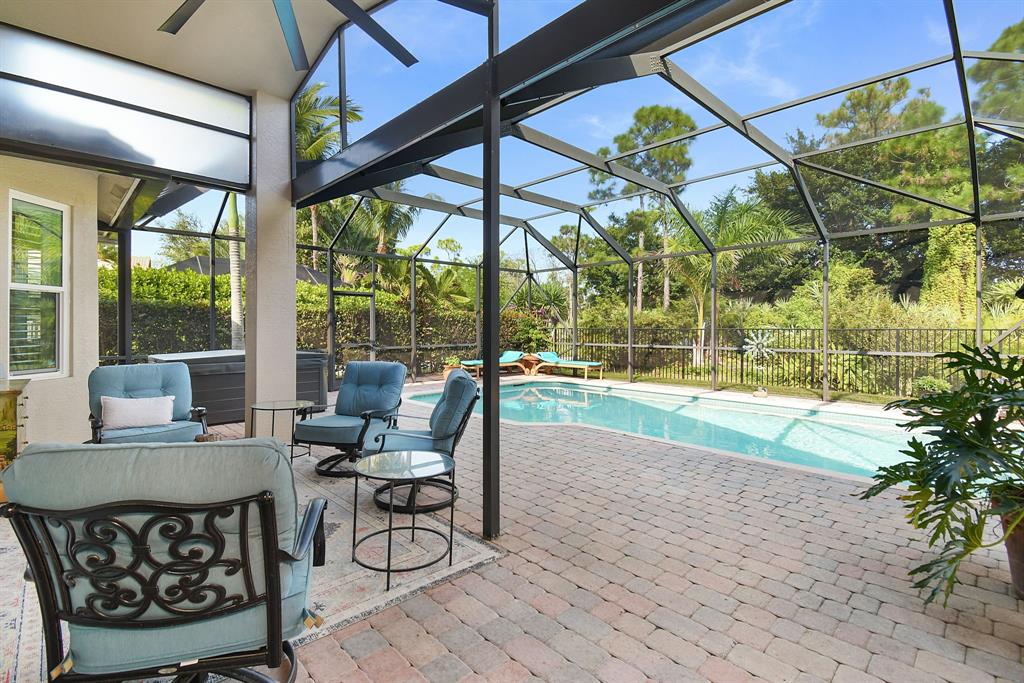6848 Southeast Twin Oaks Circle Stuart, FL 34997 - Photo 41 of 70 a outdoor space with the couches and dining table with the garden view