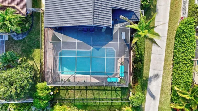 a front view of a house with a garden and tree