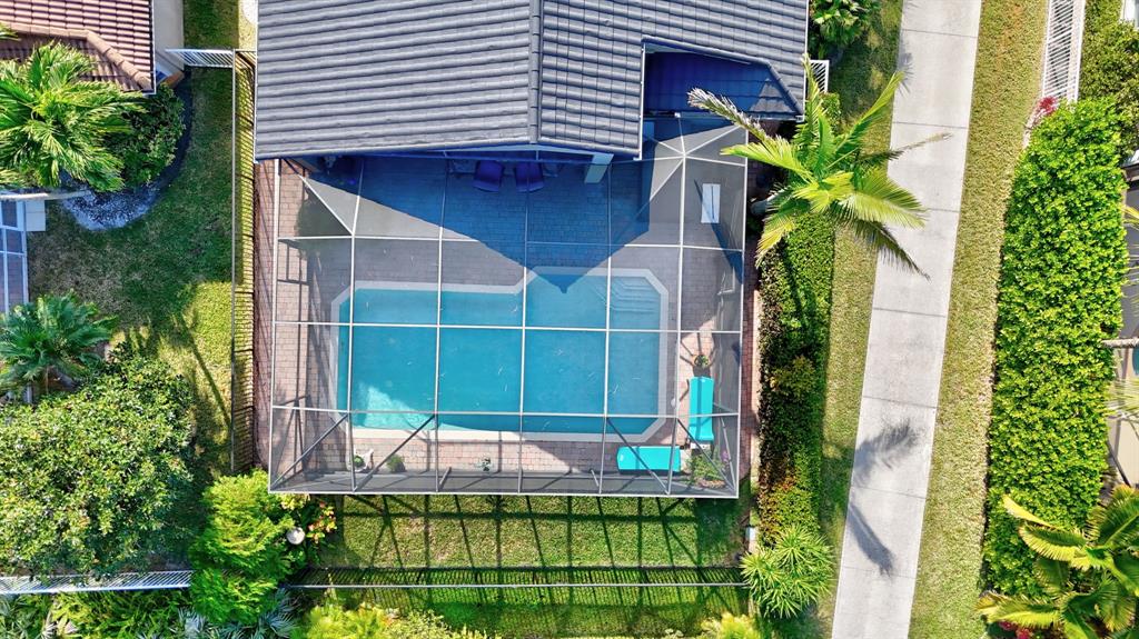 6848 Southeast Twin Oaks Circle Stuart, FL 34997 - Photo 44 of 70 a front view of a house with a yard and potted plants