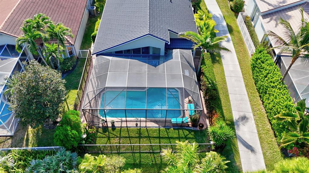 6848 Southeast Twin Oaks Circle Stuart, FL 34997 - Photo 45 of 70 a view of a tall white house with a yard and potted plants