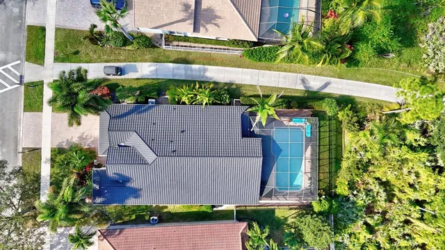 a view of a house with pool and chairs