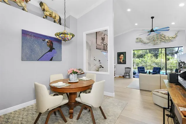 a living room with furniture large window and flat screen tv