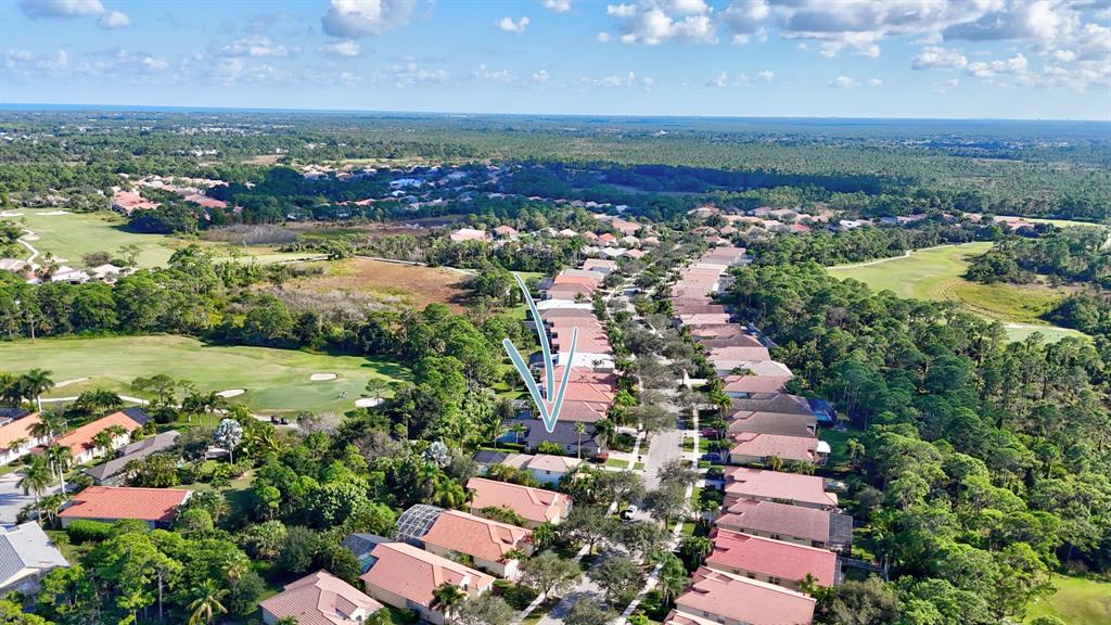 6848 Southeast Twin Oaks Circle Stuart, FL 34997 - Photo 51 of 70 an aerial view of a city with lots of residential buildings ocean and mountain view in back